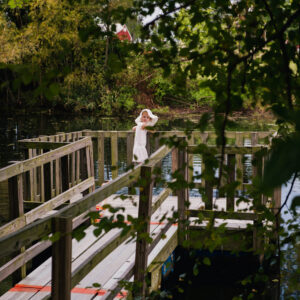 photo Through the Trees - I took this shot of my daughter as she was feeding the fish from the floating pier.  Taken on September 8, 2016 by Amanda Augsburger
