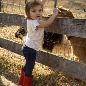photo Alice: Friend of the Goats - Taken on March 14th, 2019 at the goat enclosure closest to the Cow Barn. Hanging out with Dakota, Basil, Seven, and other goat friends by Samantha Baugher