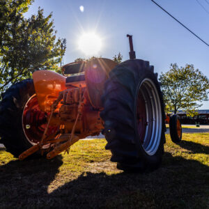 photo Sunlit Orange Tractor - Taken next to the sawmill on October 22, 2023 by Jessica Phipps