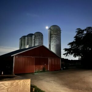 photo Nightlight - The moon peeking between the silos to light up the farm on July 23, 2023 by Luke Railsback