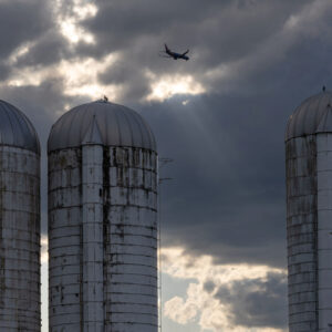 photo Fly By - A near perfectly timed airplane flying between the silos with a little light shining, taken on May 30, 2024. by Jason Bourdette
