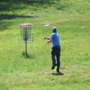 photo Final Throw for Hole Four - On May 26, 2025, I took this photo path leading from the final parking lot after the playground. The player, of course, was on the frisbee golf course leading to basket 4. by Mirjam Spaar