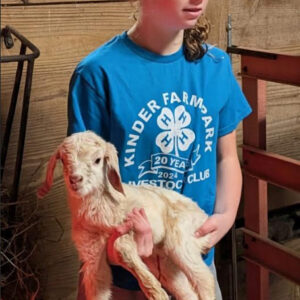 photo 4H Member Clara Holding one of Blue Snow's Triplets - Taken in the small barn on January 17, 2026. by Ranger Kerry Brooks